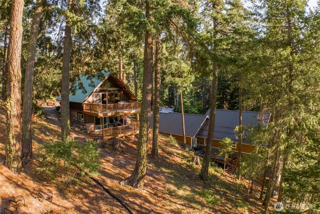 a view of backyard with deck and outdoor seating