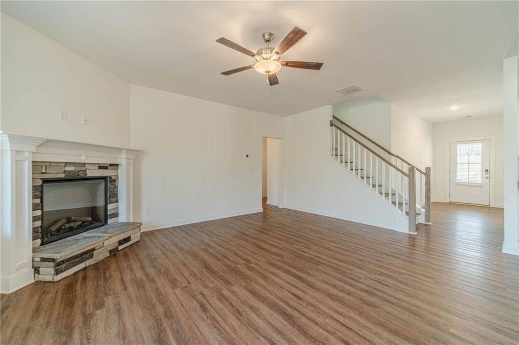 1548 Ridgewood Court Monroe, GA 30656 - Photo 13 of 59 a view of an empty room with wooden floor and a fireplace
