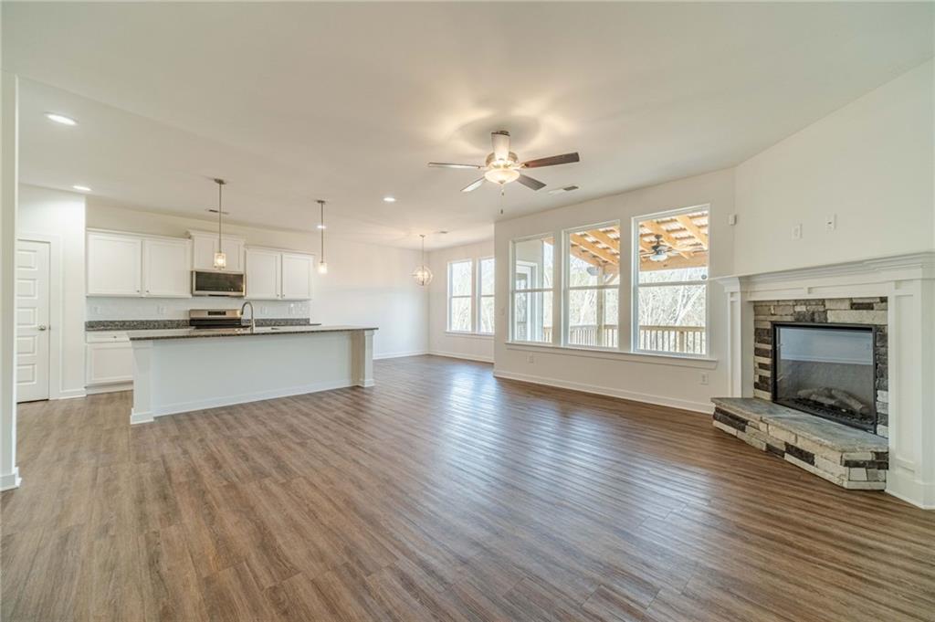 1548 Ridgewood Court Monroe, GA 30656 - Photo 15 of 59 a view of an empty room with a kitchen and a kitchen counter top