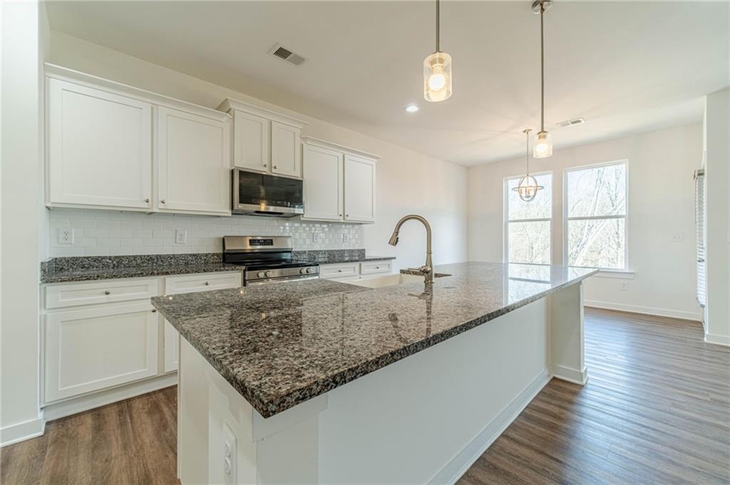 1548 Ridgewood Court Monroe, GA 30656 - Photo 18 of 63 a kitchen with sink a window and appliances