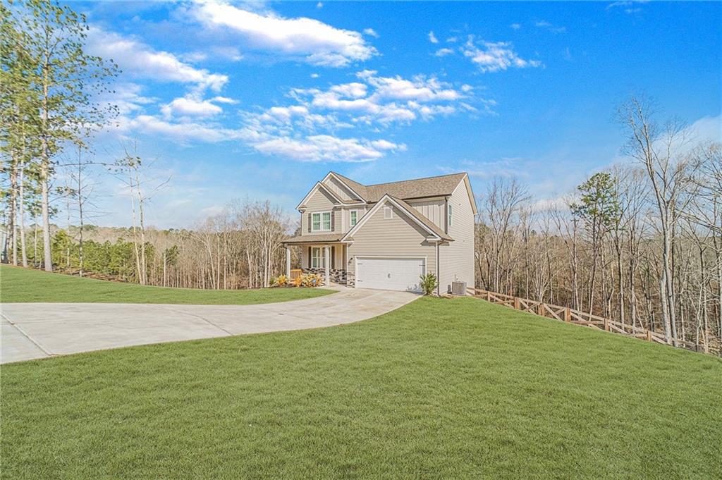1548 Ridgewood Court Monroe, GA 30656 - Photo 2 of 63 a view of an house with backyard and bushes