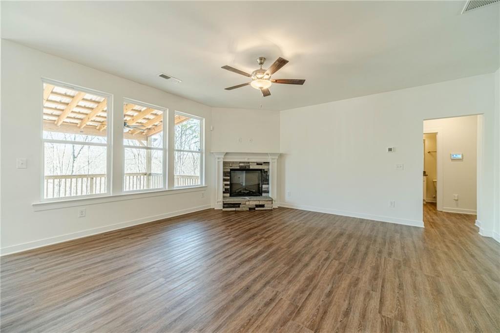 1548 Ridgewood Court Monroe, GA 30656 - Photo 25 of 63 a view of empty room with wooden floor and fan