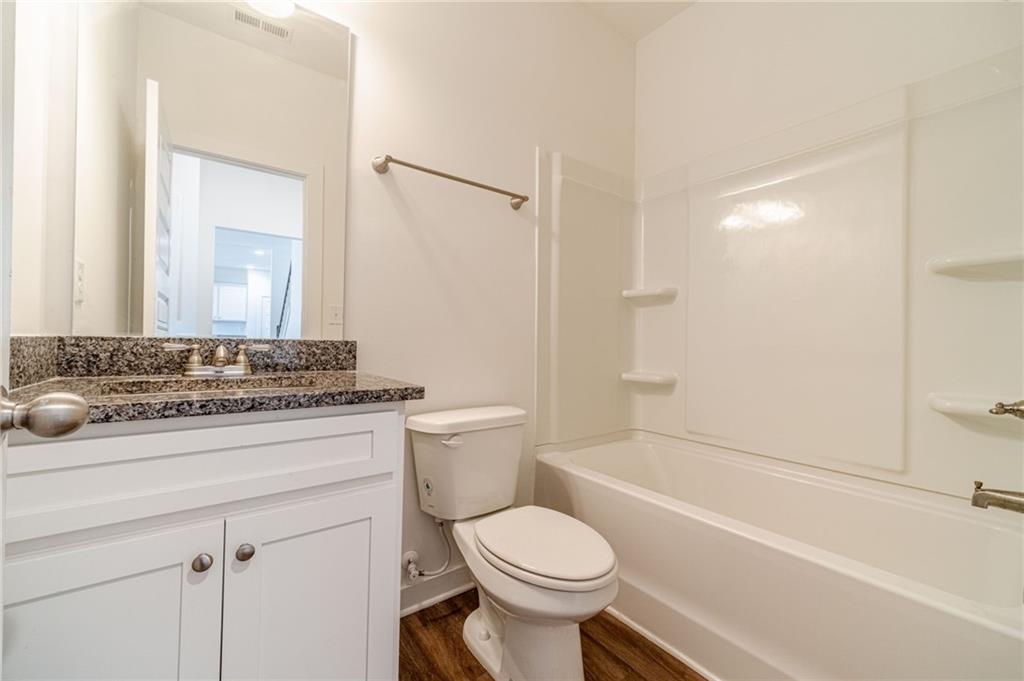 1548 Ridgewood Court Monroe, GA 30656 - Photo 26 of 63 a bathroom with a sink toilet vanity and shower
