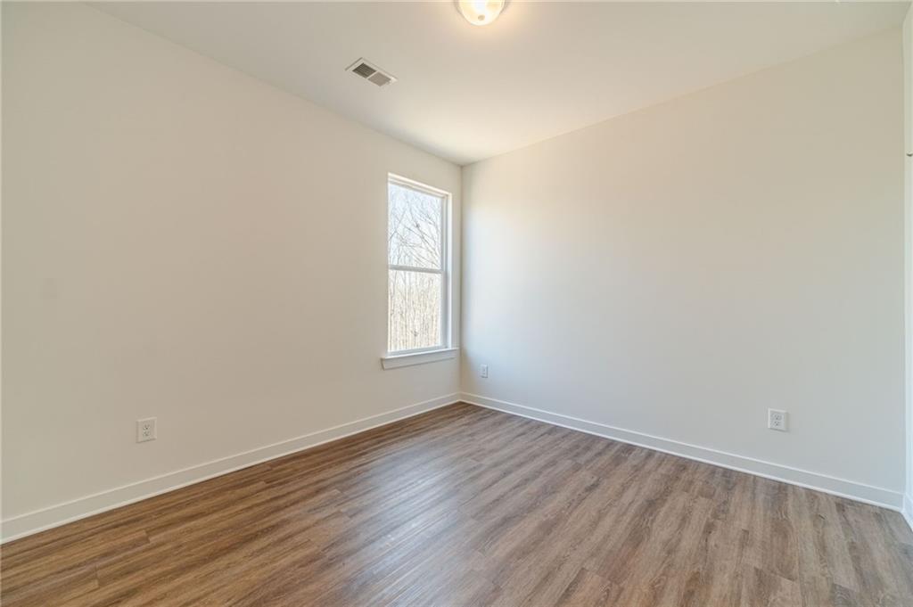 1548 Ridgewood Court Monroe, GA 30656 - Photo 27 of 63 an empty room with wooden floor and windows