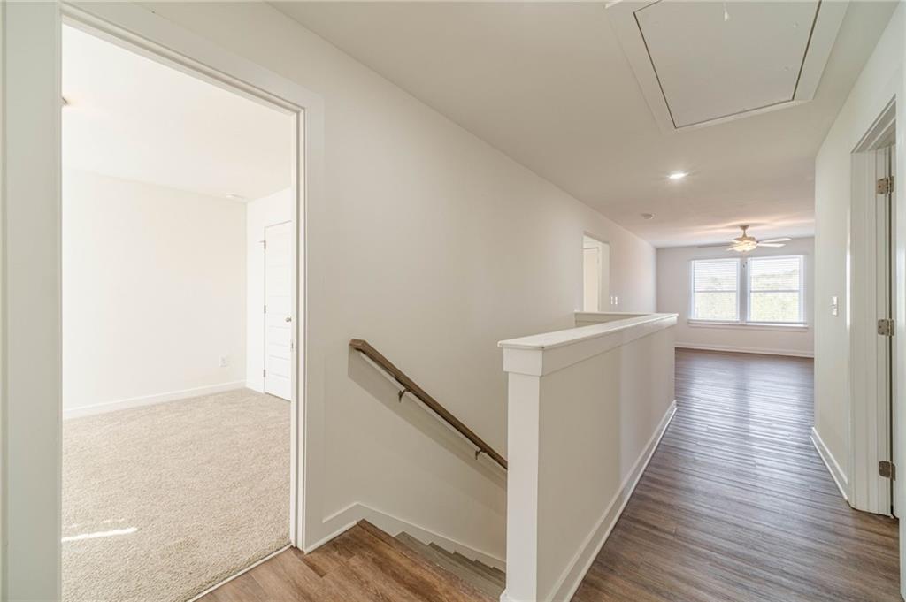 1548 Ridgewood Court Monroe, GA 30656 - Photo 29 of 63 a view of a hallway with wooden floor and staircase