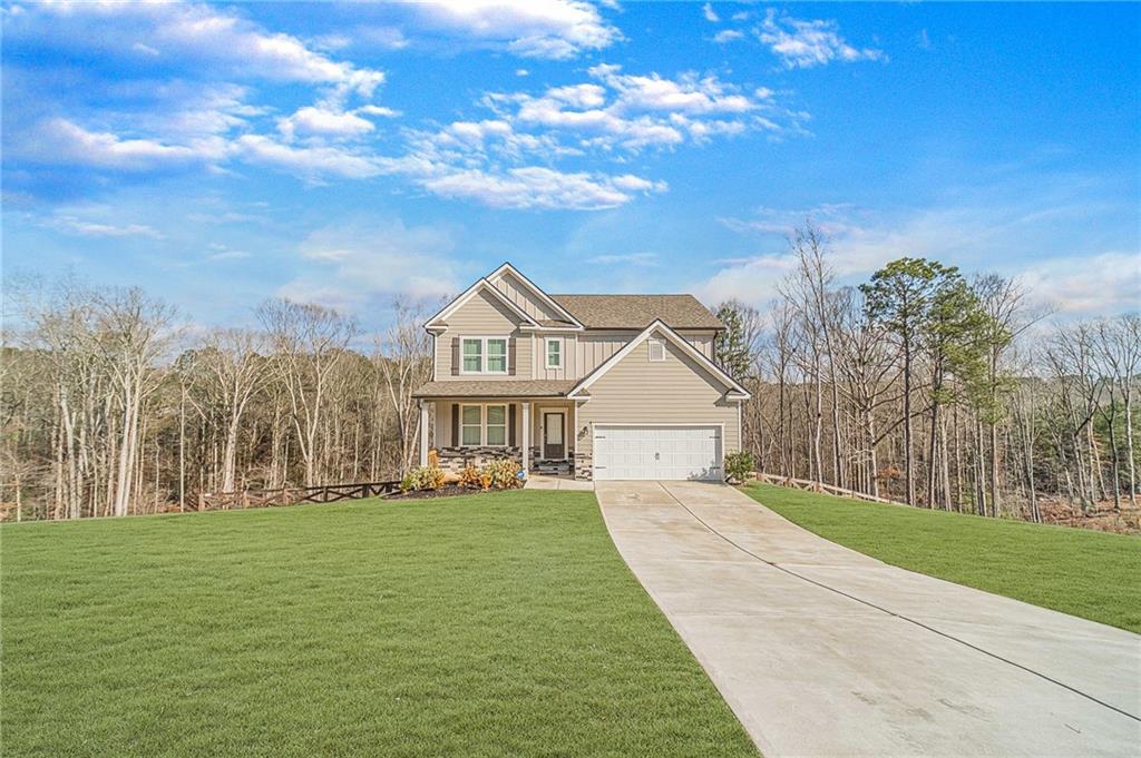 1548 Ridgewood Court Monroe, GA 30656 - Photo 3 of 63 a front view of a house with a yard and trees