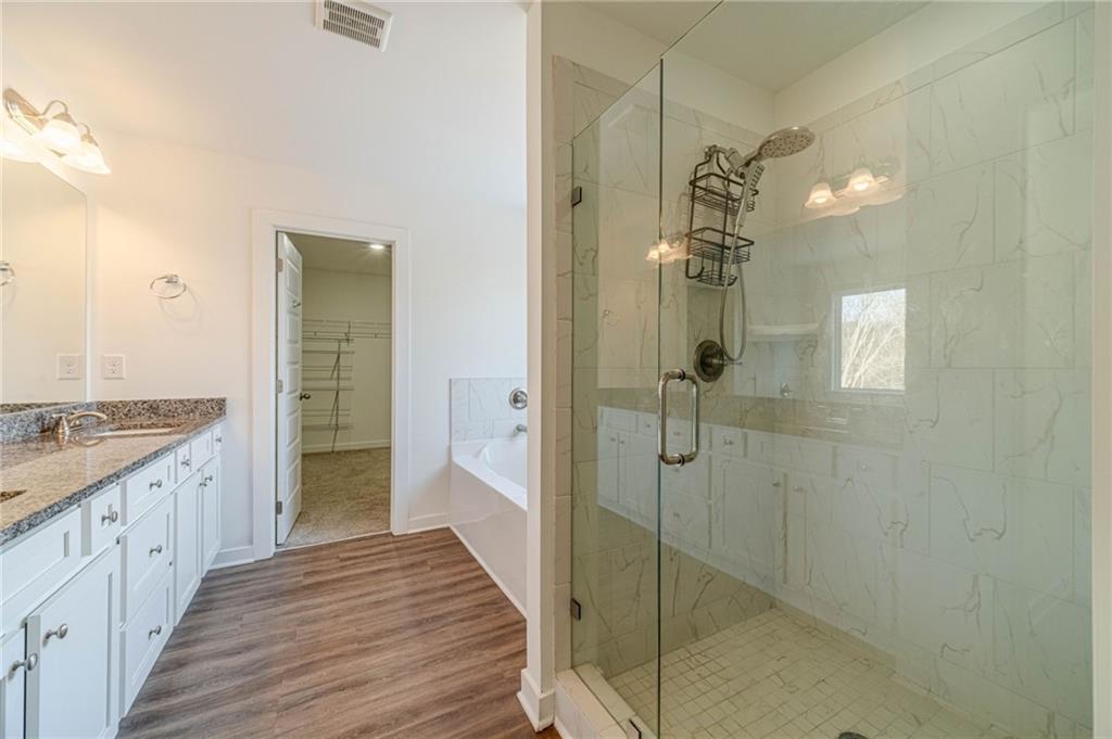 1548 Ridgewood Court Monroe, GA 30656 - Photo 32 of 59 a bathroom with a granite countertop shower a sink and mirror