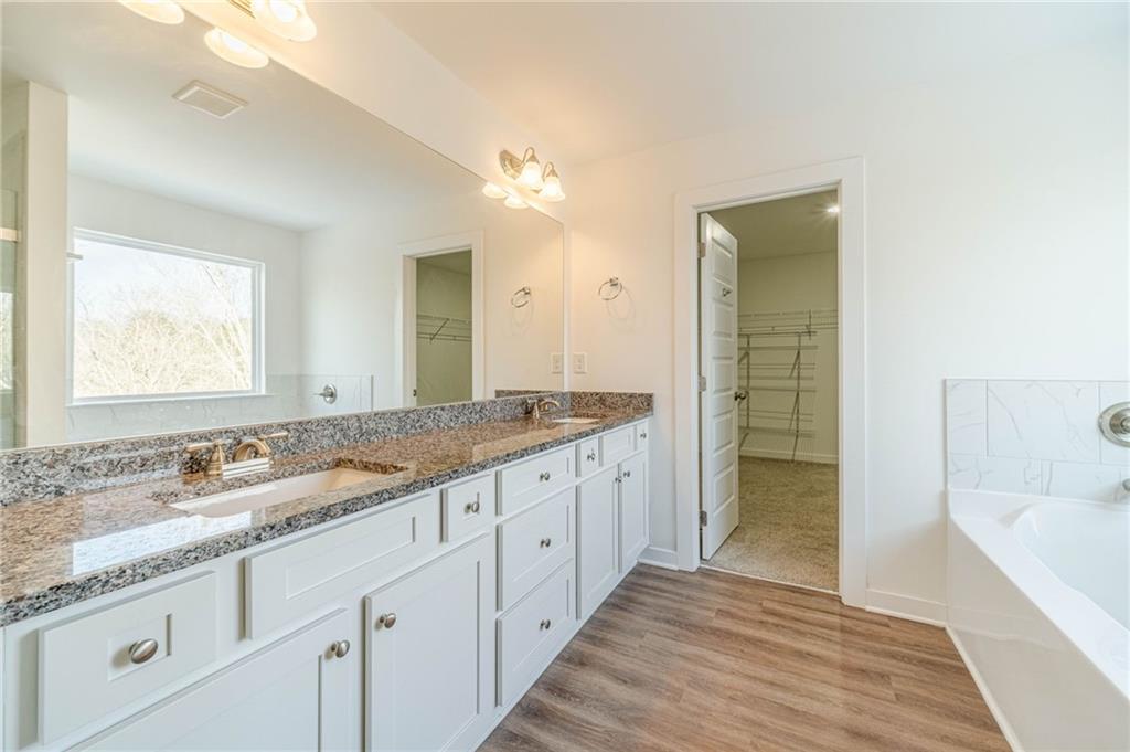 1548 Ridgewood Court Monroe, GA 30656 - Photo 33 of 59 a bathroom with granite countertop double vanity and a shower