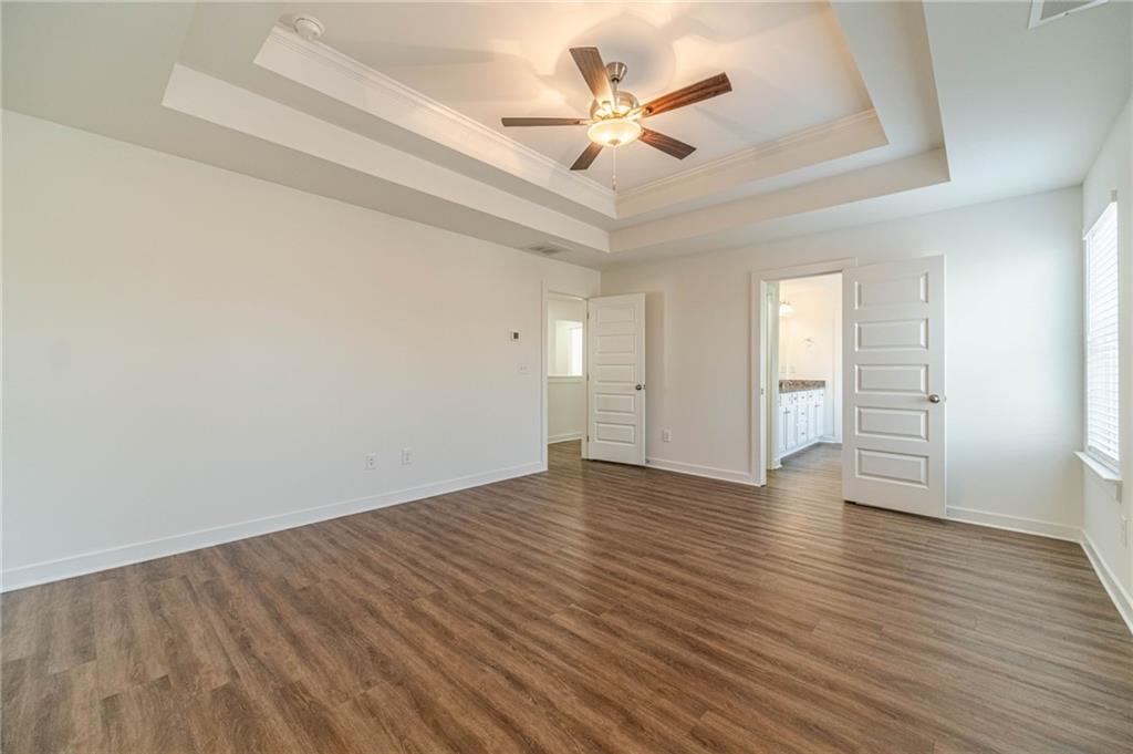 1548 Ridgewood Court Monroe, GA 30656 - Photo 39 of 63 an empty room with wooden floor and ceiling fan