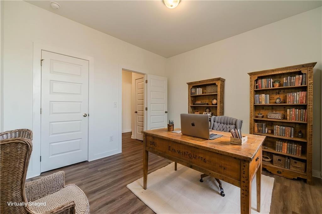 1548 Ridgewood Court Monroe, GA 30656 - Photo 6 of 63 a view of a workspace with furniture and wooden floor
