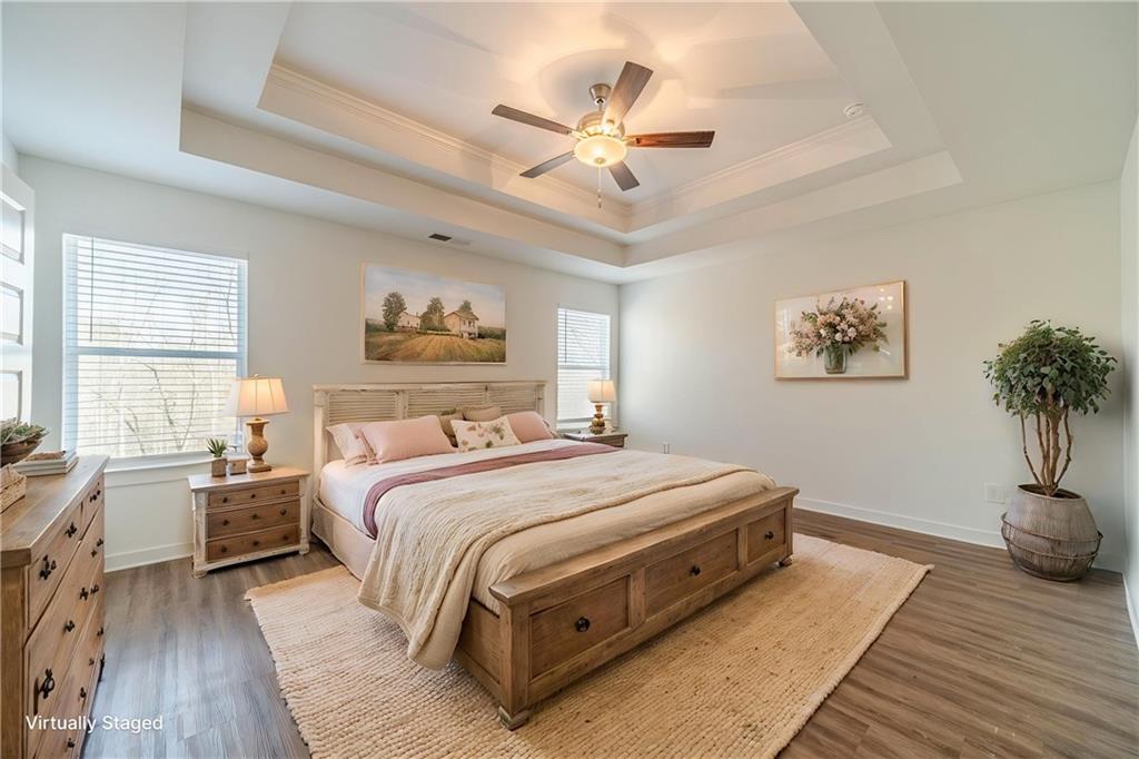1548 Ridgewood Court Monroe, GA 30656 - Photo 7 of 63 a spacious bedroom with a large bed and a chandelier