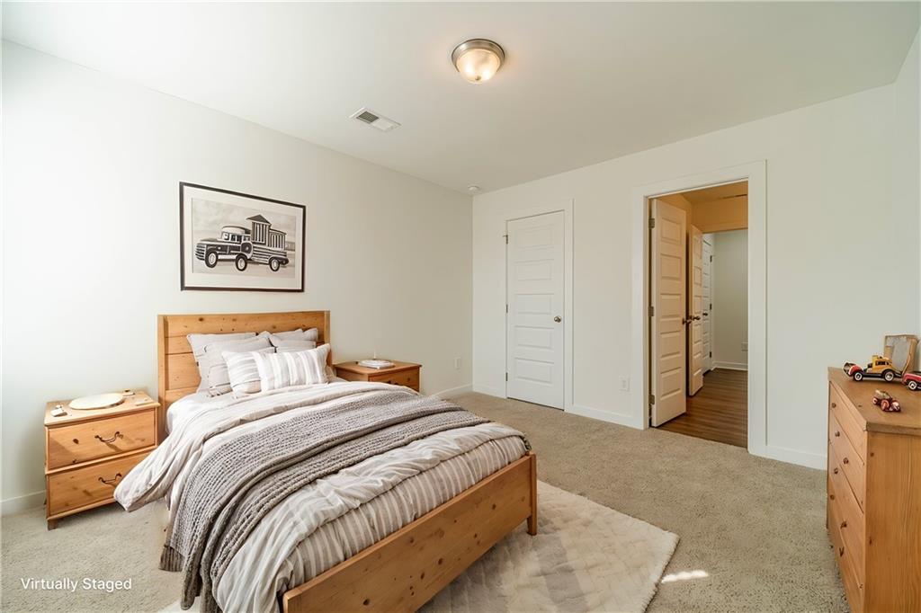 1548 Ridgewood Court Monroe, GA 30656 - Photo 9 of 63 a bedroom with a bed and a painting on the wall