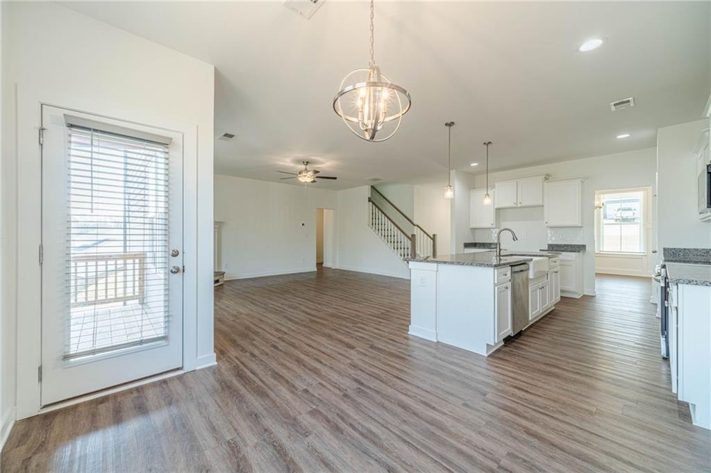 1548 Ridgewood Court Monroe, GA 30656 - Photo 10 of 59 a view of kitchen and hall with wooden floor