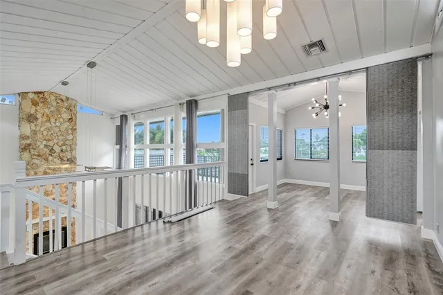a view of hallway with stairs and wooden floor