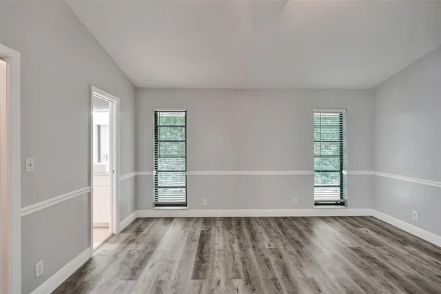 an empty room with windows and closet
