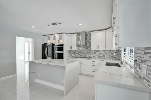 a kitchen with stainless steel appliances granite countertop a sink and cabinets
