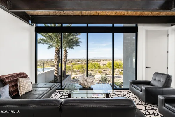 a bedroom with a bed and a large window