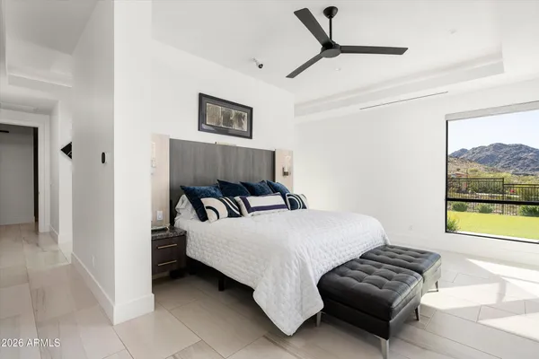 a bedroom with a bed and a painting on the wall