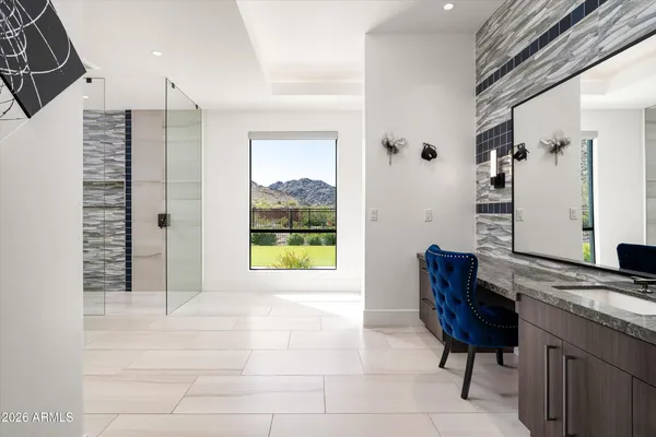 a bathroom with a granite countertop sink a toilet a mirror and shower