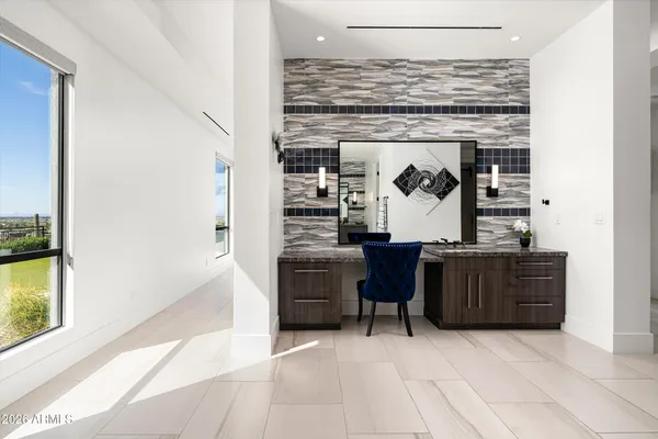 a kitchen with stainless steel appliances kitchen island granite countertop a refrigerator a stove a microwave oven a sink with a dining table and chairs