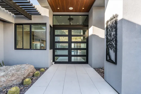 a kitchen with stainless steel appliances kitchen island granite countertop a table chairs sink and cabinets