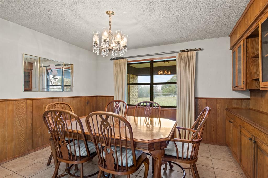 7777 Farm To Market 1001 Cookville, TX 75558 - Photo 12 of 30 a view of a dining room with furniture a chandelier and wooden floor