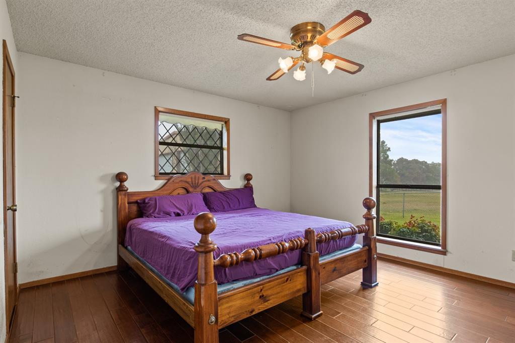 7777 Farm To Market 1001 Cookville, TX 75558 - Photo 14 of 30 a bedroom with a bed and a window