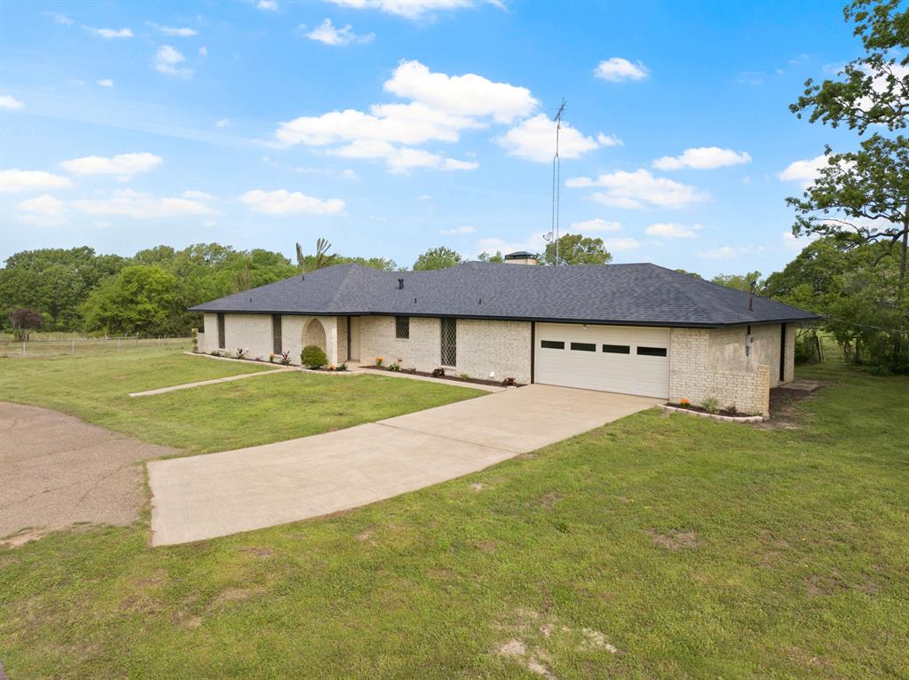 7777 Farm To Market 1001 Cookville, TX 75558 - Photo 2 of 30 a view of big house with a big yard