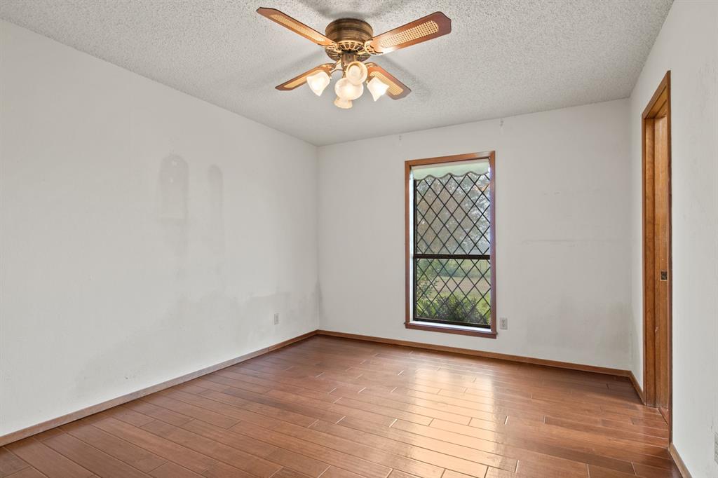 7777 Farm To Market 1001 Cookville, TX 75558 - Photo 21 of 30 wooden floor in an empty room with a window