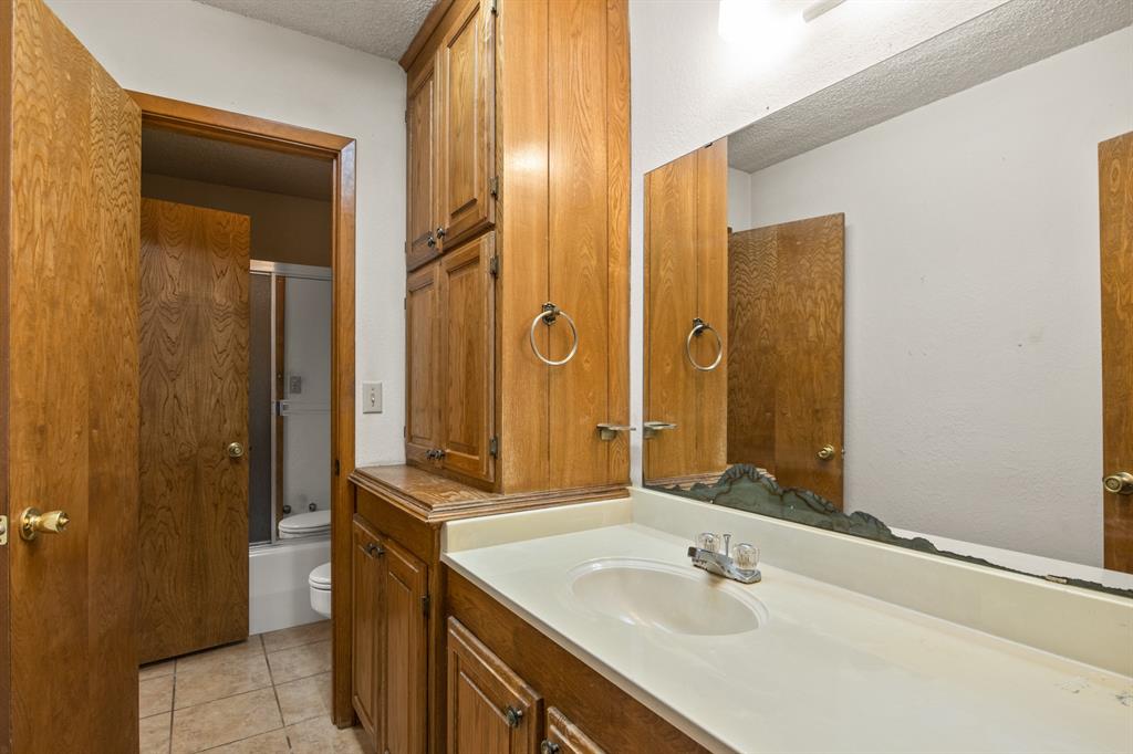 7777 Farm To Market 1001 Cookville, TX 75558 - Photo 22 of 30 a bathroom with a sink and a mirror