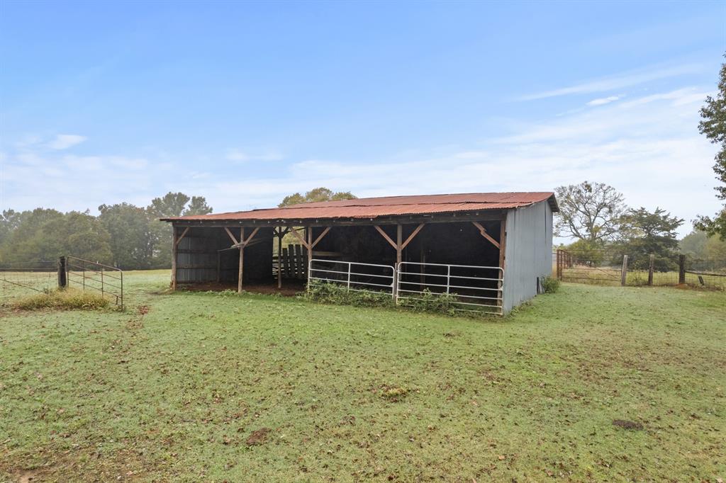 7777 Farm To Market 1001 Cookville, TX 75558 - Photo 25 of 30 a view of a barn in the middle of a yard