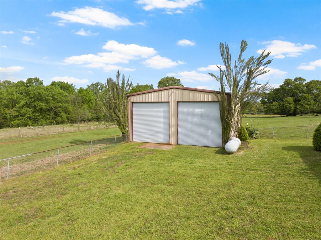 7777 Farm To Market 1001 Cookville, TX 75558 - Photo 4 of 30 a view of a house with a yard