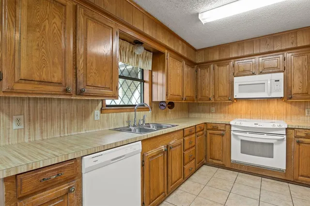 a kitchen with a sink stove and refrigerator