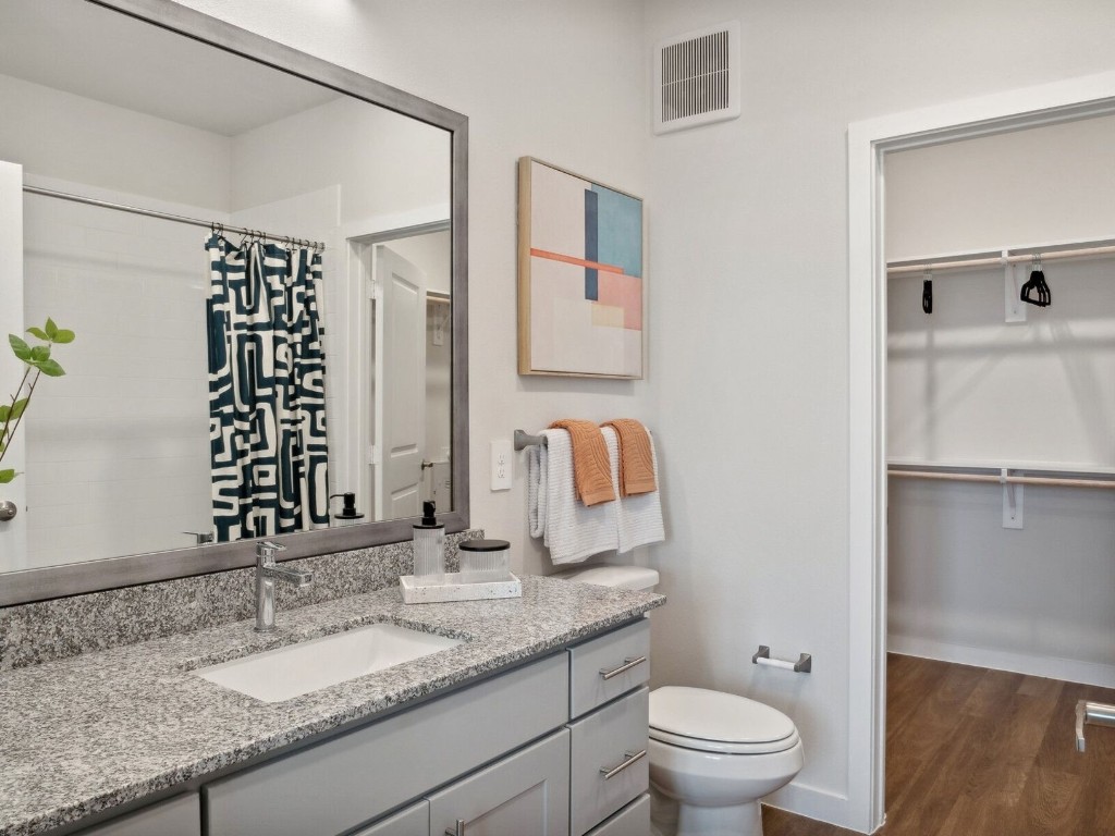 23100 Clay Road, Unit 7203 Katy, TX 77493 - Photo 8 of 29 a bathroom with a granite countertop sink toilet and shower