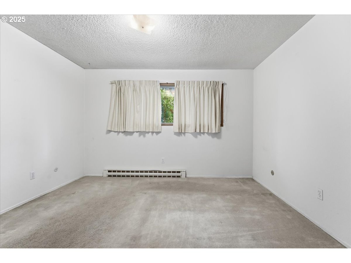6835 Southwest Capitol Hill Road, Unit 30 Portland, OR 97219 - Photo 20 of 33 a view of an empty room with a window