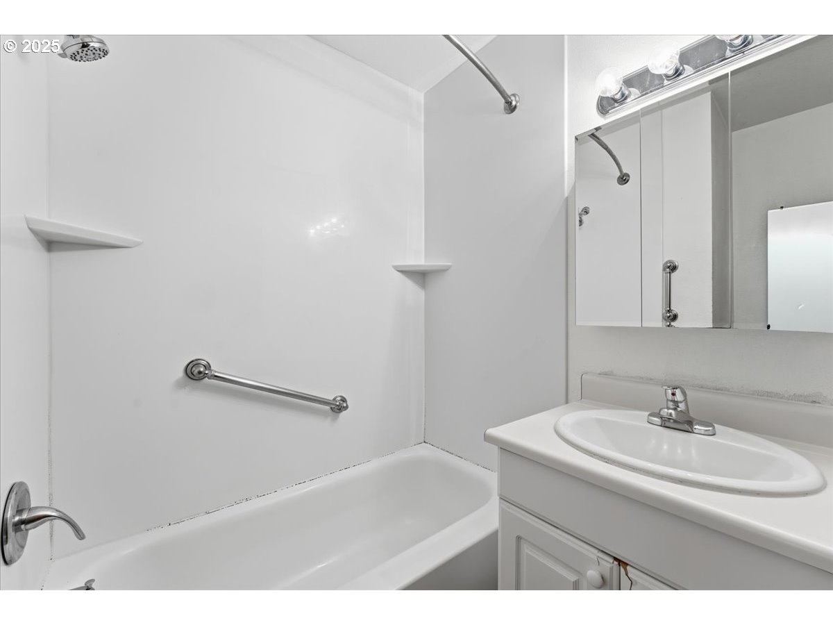 6835 Southwest Capitol Hill Road, Unit 30 Portland, OR 97219 - Photo 22 of 33 a bathroom with a sink and a mirror