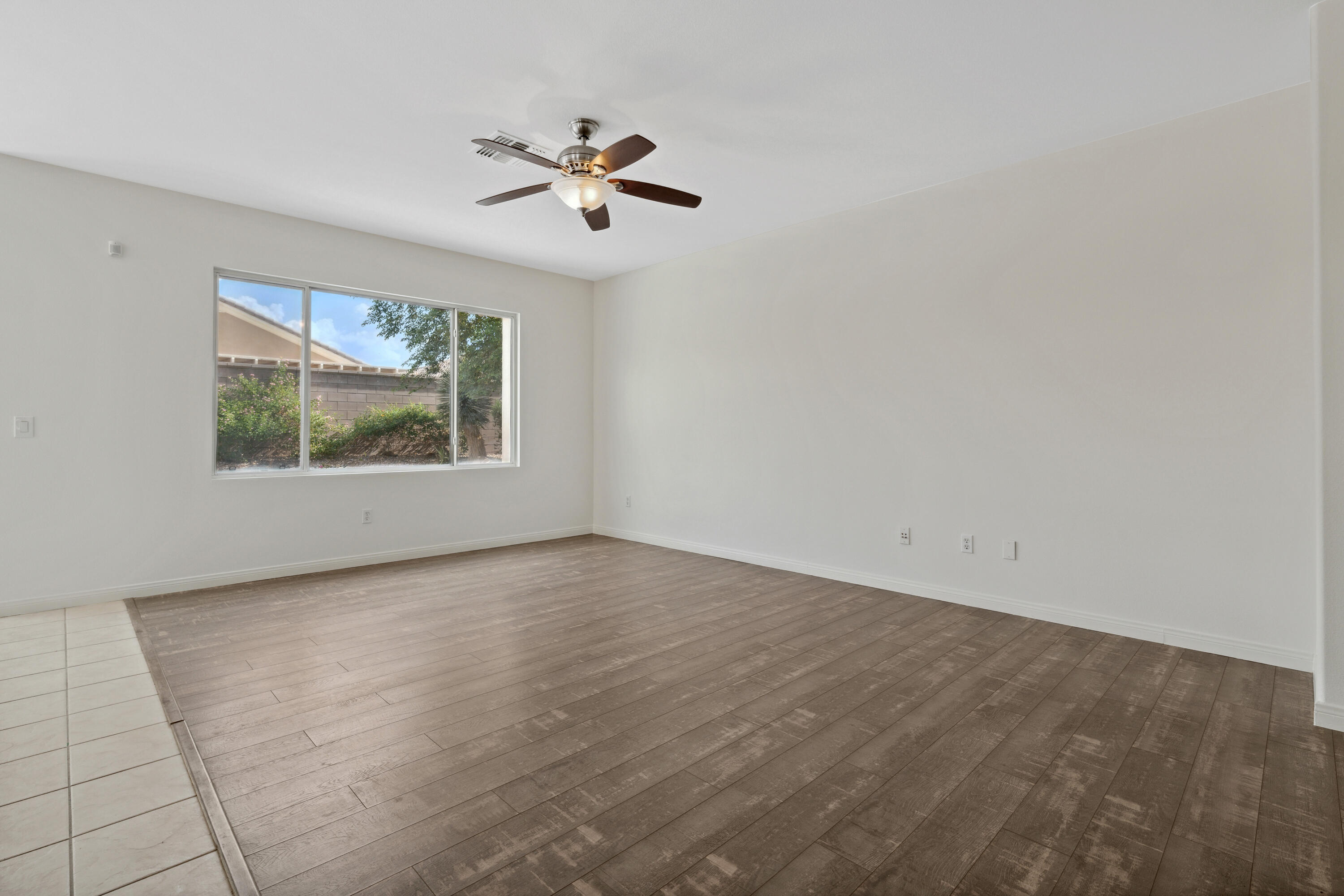 78640 Rainswept Way Palm Desert, CA 92211 - Photo 16 of 37 an empty room with windows and fan