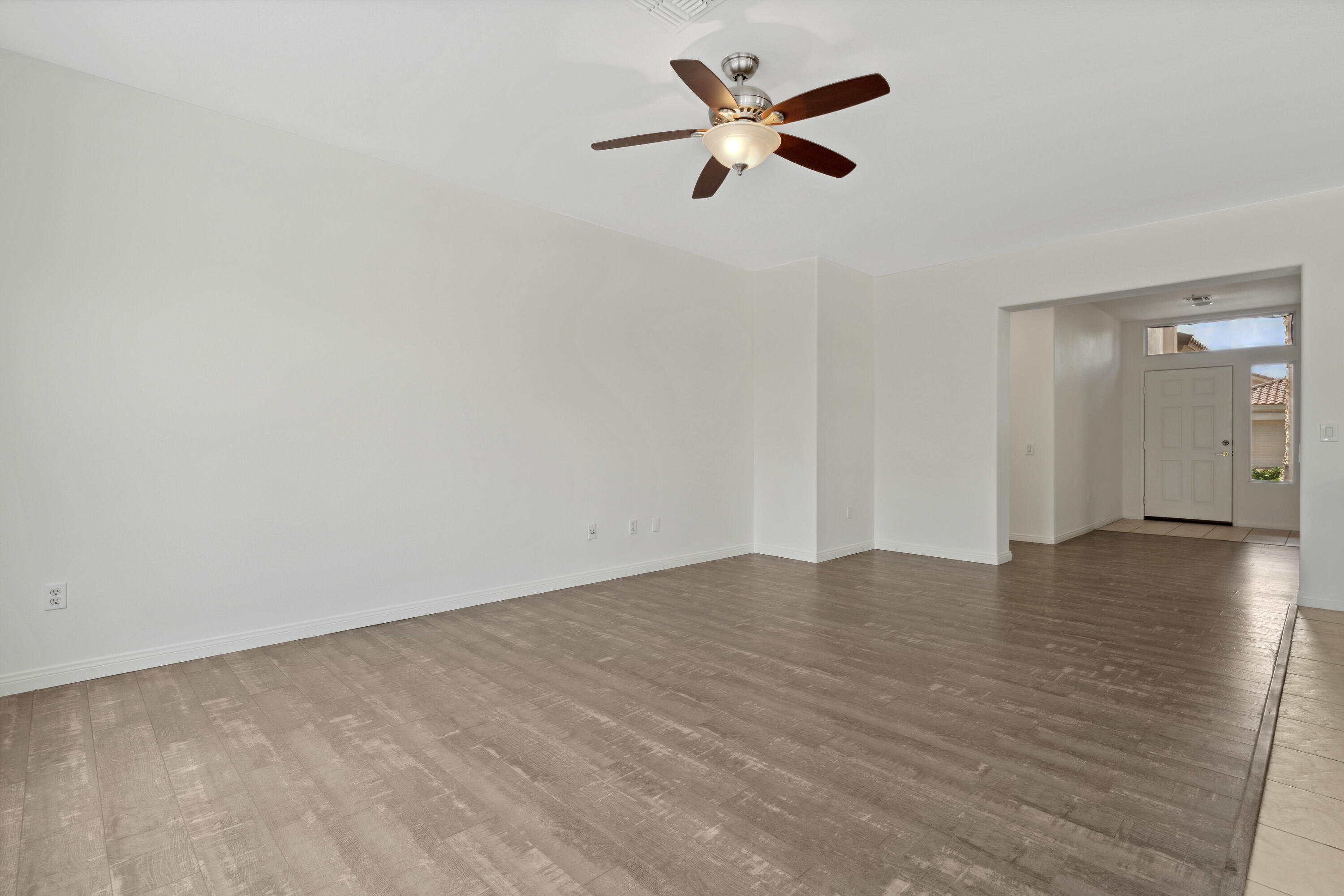 78640 Rainswept Way Palm Desert, CA 92211 - Photo 18 of 37 an empty room with wooden floor and a ceiling fan