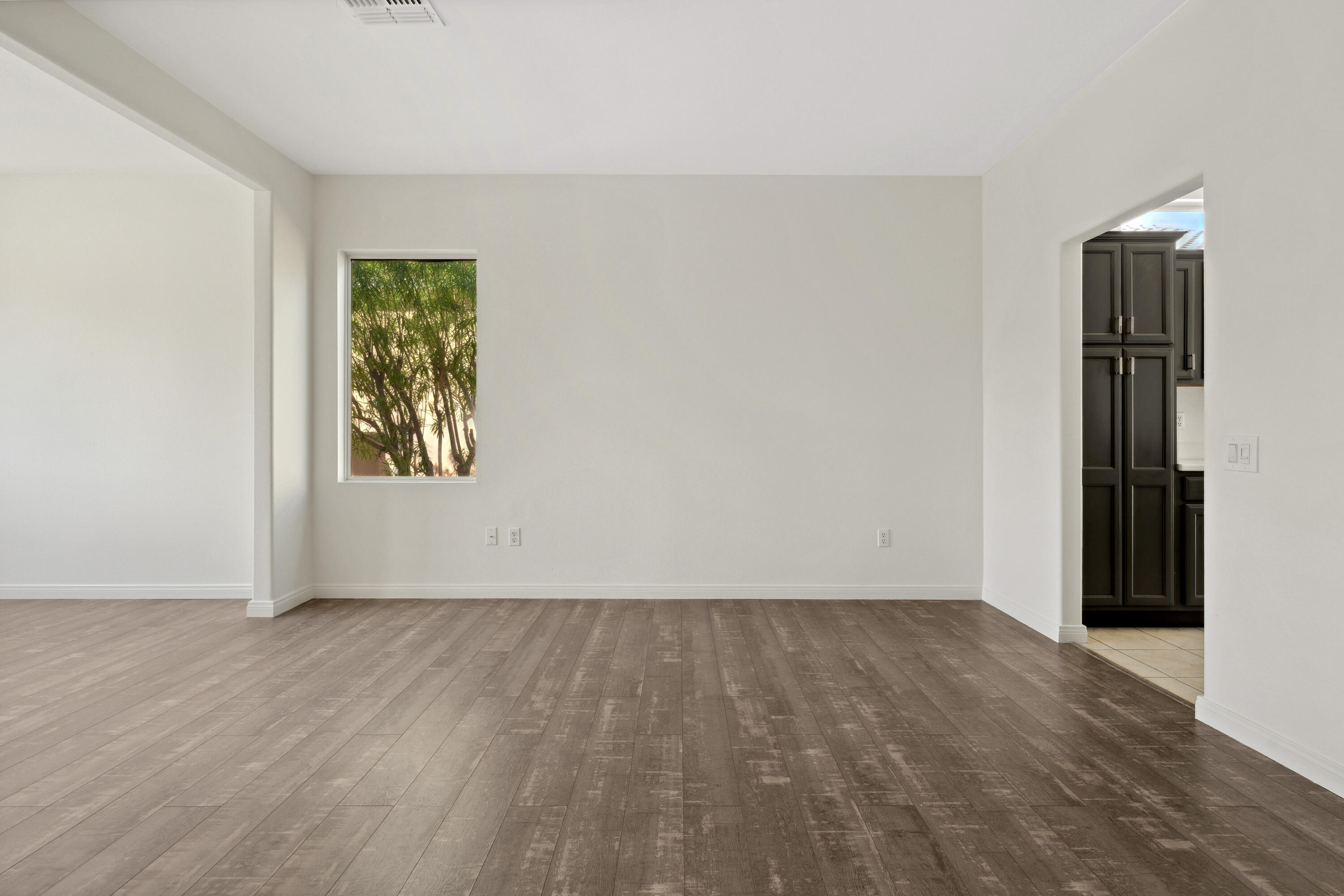 78640 Rainswept Way Palm Desert, CA 92211 - Photo 24 of 37 an empty room with a window and wooden floor