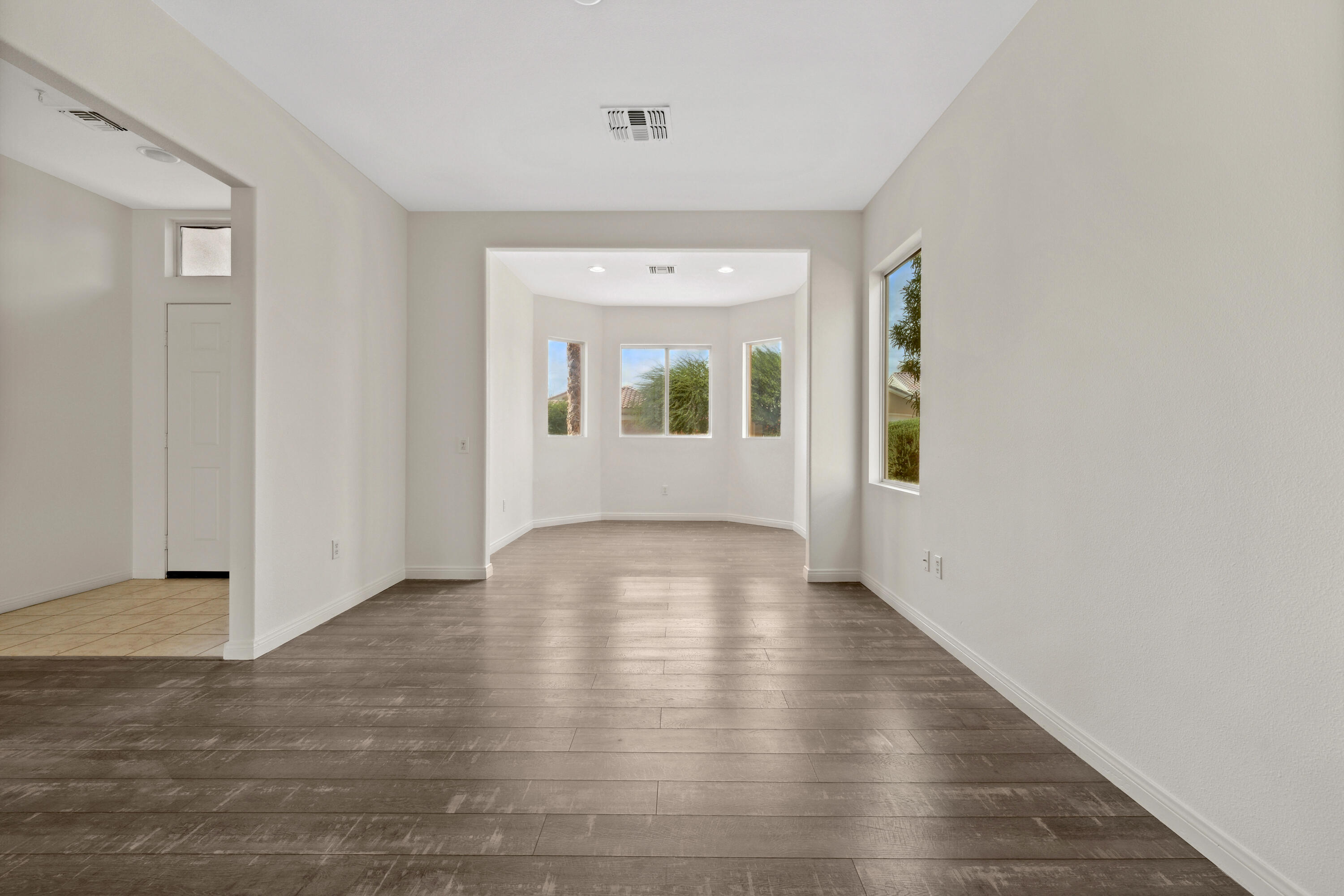 78640 Rainswept Way Palm Desert, CA 92211 - Photo 26 of 37 a view of an empty room with wooden floor and a window