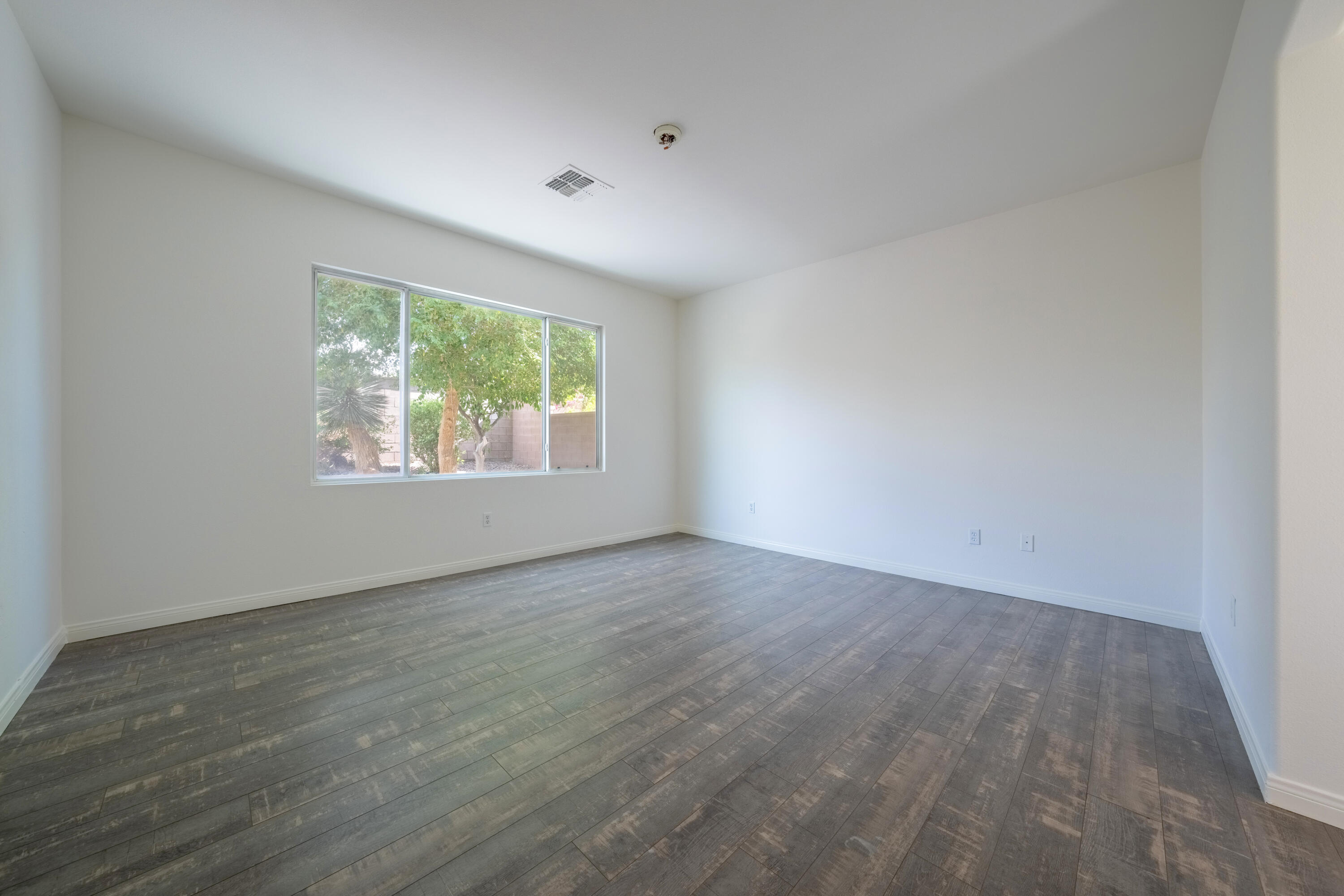 78640 Rainswept Way Palm Desert, CA 92211 - Photo 30 of 37 wooden floor in an empty room with a window