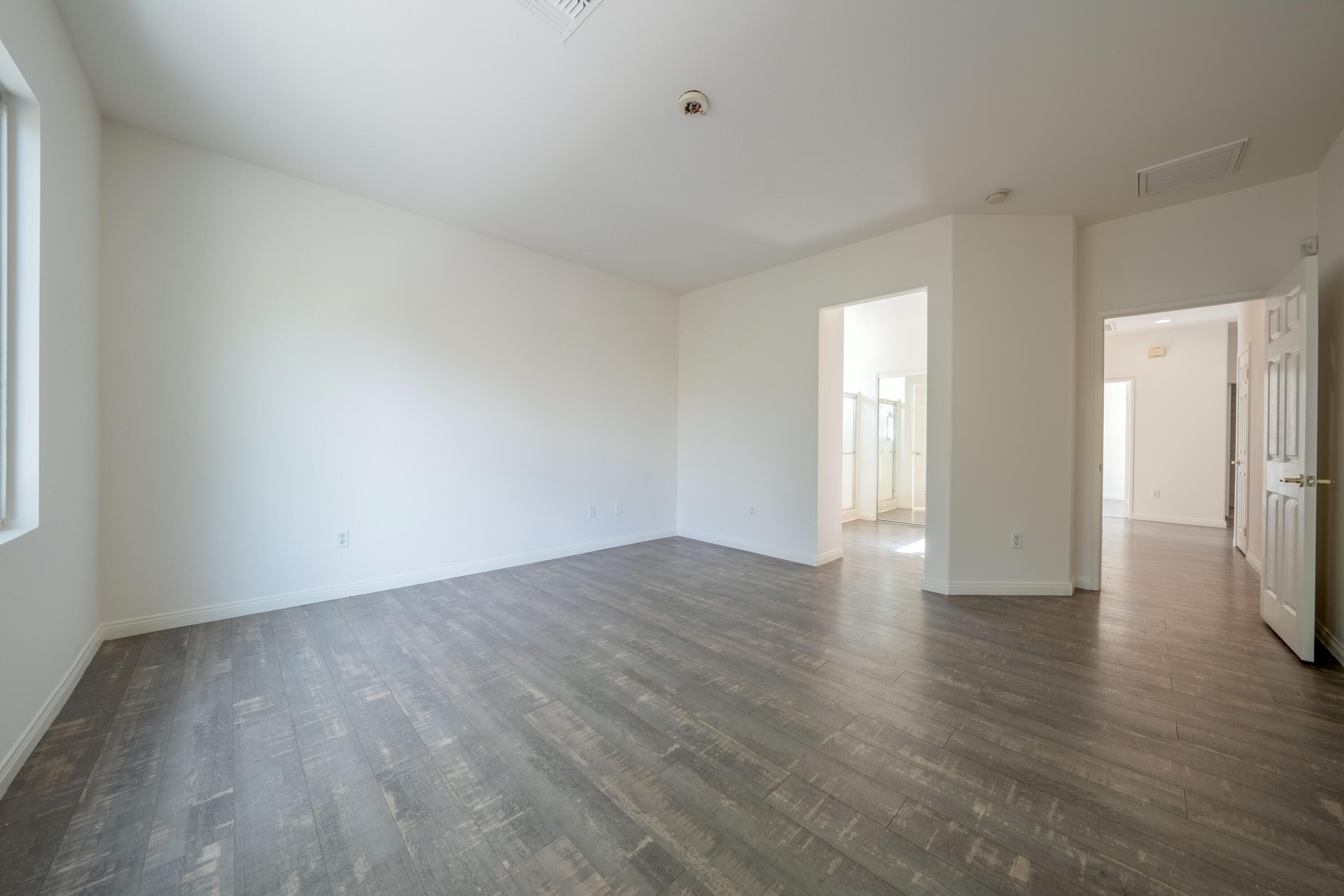 78640 Rainswept Way Palm Desert, CA 92211 - Photo 32 of 37 a view of an empty room with wooden floor and window