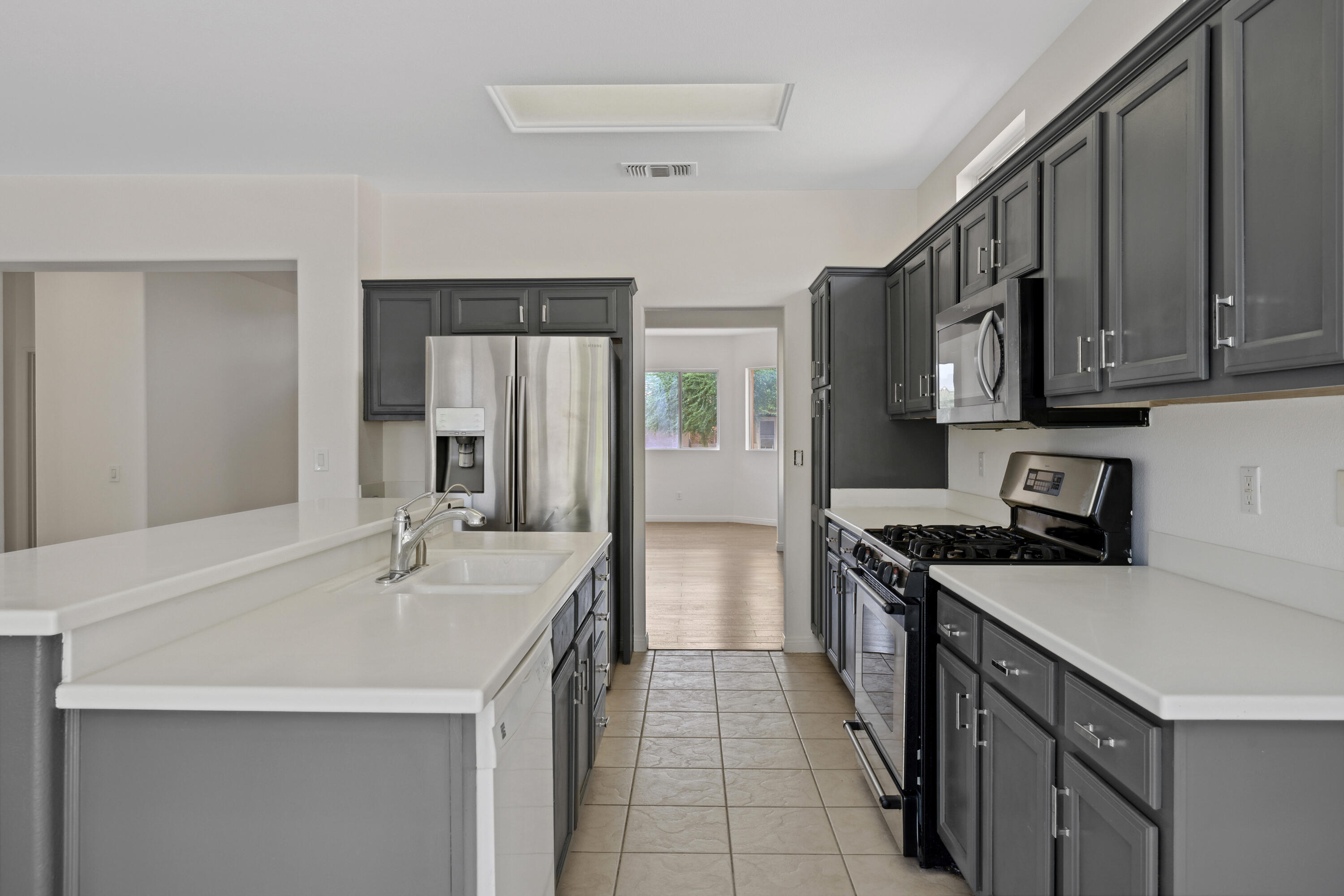 78640 Rainswept Way Palm Desert, CA 92211 - Photo 10 of 37 a kitchen with a sink stove and cabinets