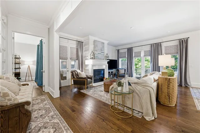 a living room with furniture and large windows