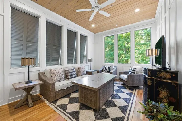 a living room with furniture and large windows