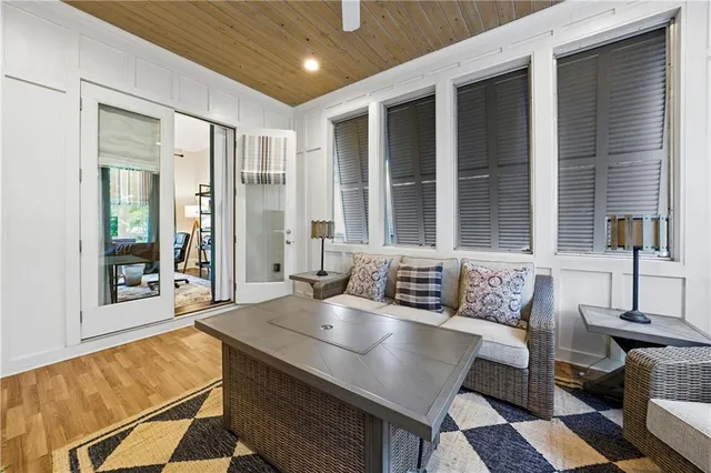a living room with furniture and a view of kitchen