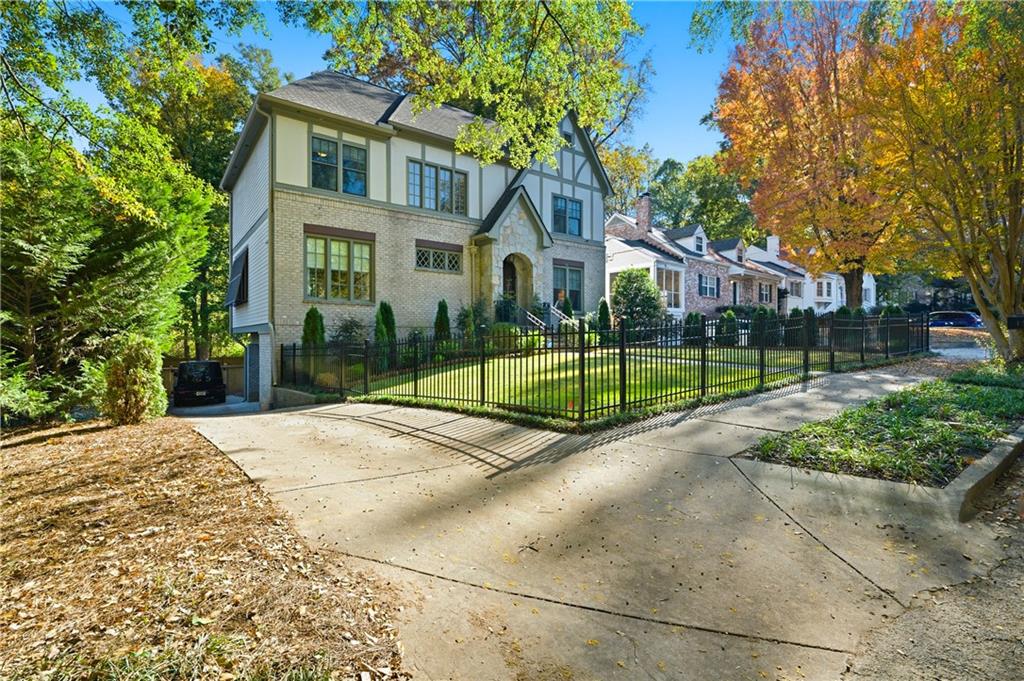 1295 Cumberland Road Northeast Atlanta, GA 30306 - Photo 3 of 71 a view of a house with a big yard plants and palm trees