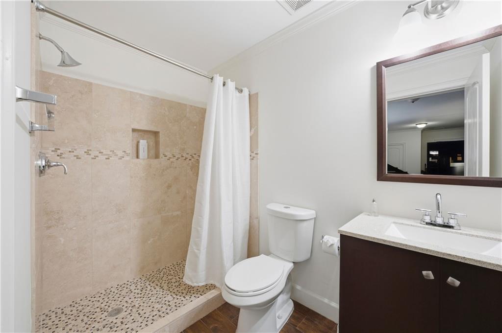 1295 Cumberland Road Northeast Atlanta, GA 30306 - Photo 45 of 71 a bathroom with a sink toilet and shower