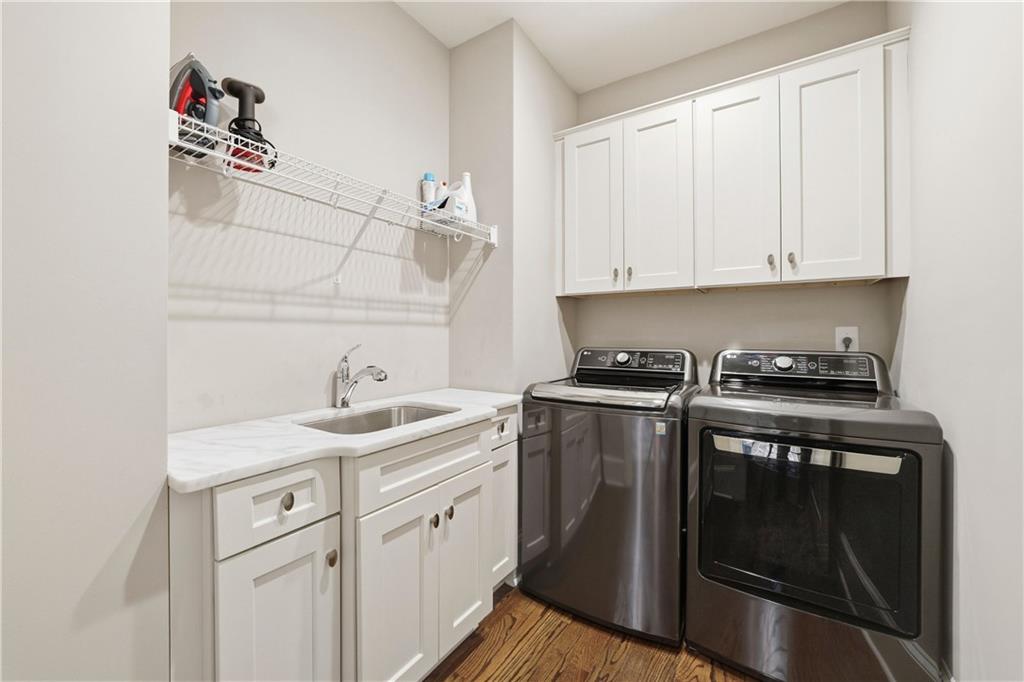 1295 Cumberland Road Northeast Atlanta, GA 30306 - Photo 49 of 71 a kitchen with a sink stove and cabinets