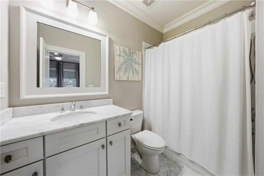 1295 Cumberland Road Northeast Atlanta, GA 30306 - Photo 52 of 71 a bathroom with a toilet a sink and a mirror